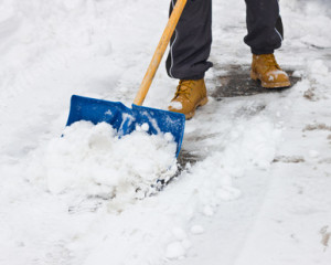 Clearing snow with shovel after storm