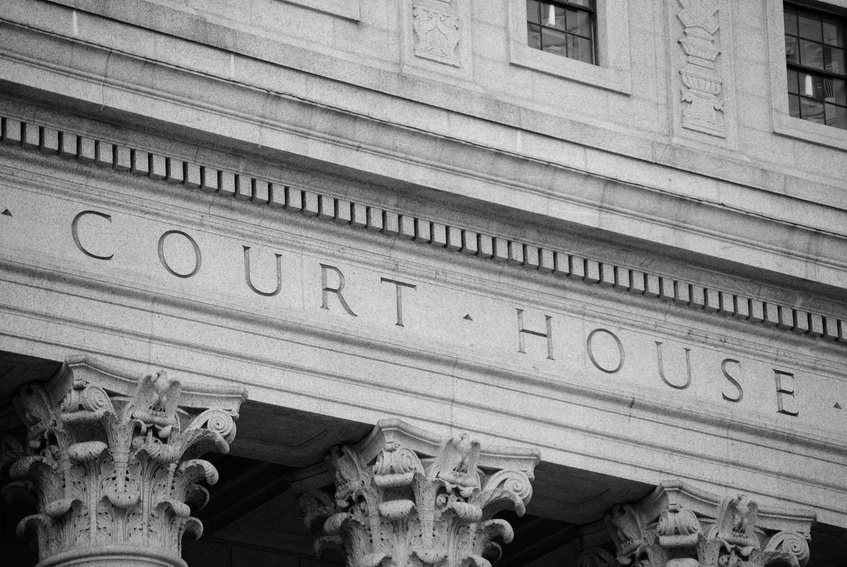 Marble courthouse building facade in black and white.