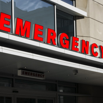 A closeup shot of the emergency room sign
